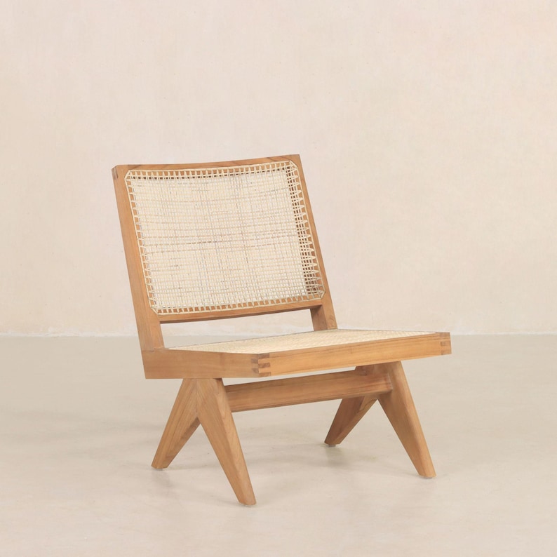 May include: A wooden chair with a woven cane seat and back. The chair has a simple, modern design with a triangular base.