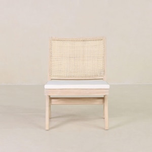 May include: A light wood chair with a woven cane back and a white cushion. The chair has a simple, modern design.