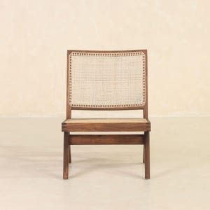 May include: A wooden chair with a woven cane seat and back. The chair has a dark brown finish and a simple, modern design.