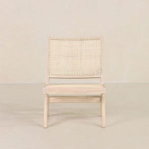 May include: A white wooden chair with a woven cane seat and back. The chair has a simple, modern design.