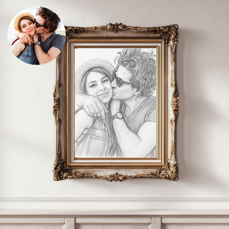 May include: A framed pencil sketch of a couple embracing and kissing, with a smaller color photo in the upper left corner. The frame is ornate with a gold finish. The sketch depicts the couple wearing casual clothing and accessories.