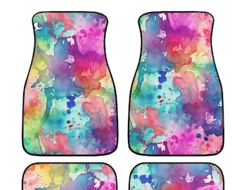May include: Set of four car floor mats featuring a watercolour splatter design in shades of pink, blue, green, and yellow.