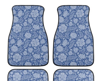 May include: Set of four car floor mats with a blue floral pattern. The mats feature a repeating design of flowers and leaves in shades of blue and white, outlined with a black border. The set includes two front mats and two rear mats.