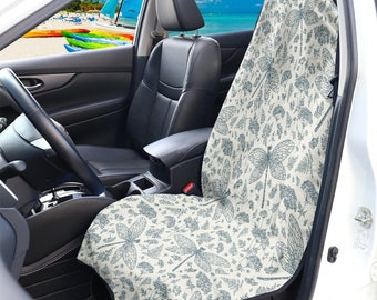 May include: A white car seat cover with a dragonfly and floral pattern. The cover is made of a soft, comfortable fabric and is designed to protect your car seats from dirt, spills, and wear and tear.