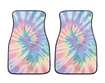 May include: Two tie-dye car floor mats in a swirl pattern of pink, blue and yellow.