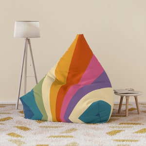 May include: A large, colourful beanbag chair with a retro-inspired design. The chair features a pattern of curved stripes in shades of green, yellow, orange, pink, purple, and blue.