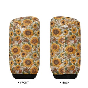 May include: A white and yellow can cooler with a sunflower pattern. The cooler has a black bottom and a white seam down the back.
