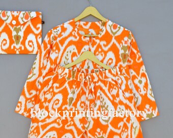 May include: A three-piece pajama set in an orange and white ikat pattern. The set includes a long-sleeved top, pants, and a matching pouch.