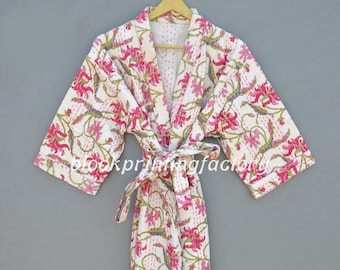 May include: A white cotton robe with a pink floral print and a matching tie belt. The robe has a traditional Japanese kimono style.