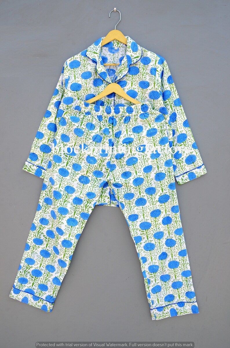 May include: A white pajama set with a blue floral print. The top has long sleeves and a button-up collar. The pants have an elastic waistband.