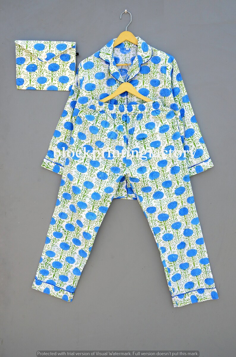 May include: A white pajama set with a blue floral print. The set includes a long-sleeved top with a button-up front and matching pants. The pajamas are made of soft cotton and are perfect for a comfortable night's sleep.