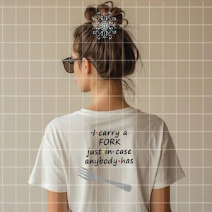 May include: White t-shirt with the text "I carry a FORK just in case anybody has" and a fork graphic. The shirt is worn by a person with sunglasses and a bun hairstyle.