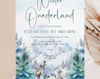May include: A blue and white winter wonderland themed first birthday party invitation with a watercolor illustration of a snowy mountain range, pine trees, a deer, a wolf, and two penguins. The text on the invitation reads "Winter Onederland" and "Join us to celebrate Elizabeth's 1st Birthday".