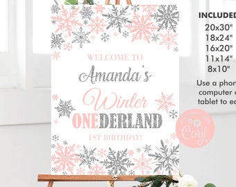 May include: A pink and silver printable sign with snowflakes and the text "Welcome to Amanda's Winter Onederland 1st Birthday!" The sign is available in multiple sizes, including 50.8cm x 76.2cm, 45.7cm x 61cm, 40.6cm x 50.8cm, 27.9cm x 35.6cm, and 20.3cm x 25.4cm.