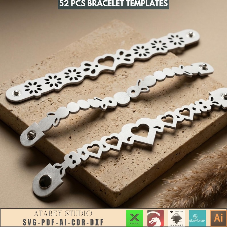 May include: Three silver bracelet templates with various cut-out designs, including hearts, flowers, and circles. The bracelets are displayed on a textured, light brown surface. The text "52 PCS BRACELET TEMPLATES" is at the top.
