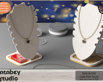 May include: A white wooden jewelry display stand with a necklace and a heart pendant. The stand has a small red box and a ring on a white base. The stand is on a gray surface. The text "Material Thickness 6mm-1/4in 3mm-1/8in" is on the left side of the image. The text "SVG-AI-DXF CDR-PDF FILES READY EASY LASER CUT FILES" is on the right side of the image.