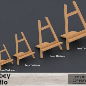 May include: Four wooden easels of different sizes, each with a 3mm, 4mm, 5mm, and 6mm thickness. The easels are made of wood and are perfect for displaying small artwork or photos.