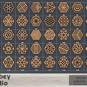 May include: A collection of 39 laser-cut wooden hexagon designs, each with a unique geometric pattern. The designs are numbered from 81 to 120 and are displayed on a dark gray background. The image includes the text "Atabey Studio" and file type information.