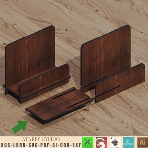 May include: A wooden phone stand with a dark brown finish. The stand is made of four pieces that fit together to create a phone holder. The stand is designed to hold a phone upright.