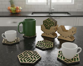 May include: Wooden coaster and holder templates with a geometric design. The coasters are hexagonal with a green and black pattern. The holders are made of light brown wood. The image also shows a green mug and white cups.