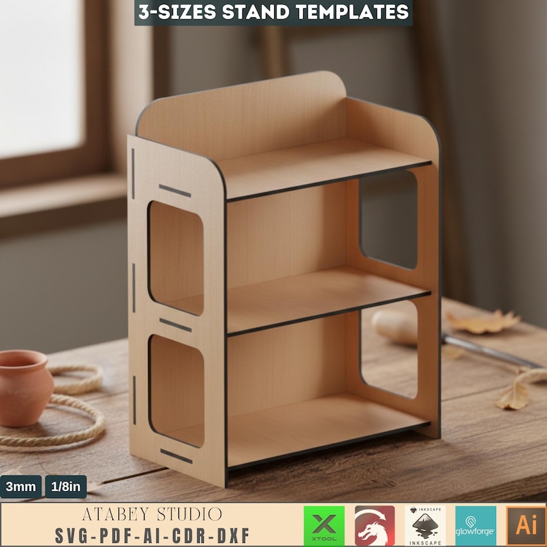 May include: A three-tiered wooden stand with a light brown finish and black edges. The stand has a rectangular shape with open sides and is labeled "3-SIZES STAND TEMPLATES". The text "ATABEY STUDIO SVG-PDF-AI-CDR-DXF" is also visible.