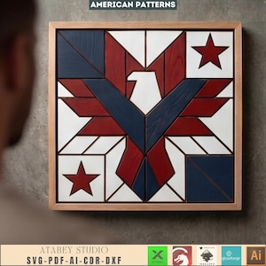 May include: A square wooden wall art piece featuring a geometric eagle design in red, white, and blue. The eagle is centered with wings spread, flanked by two red stars in opposite corners. The artwork is enclosed in a light-toned wooden frame.