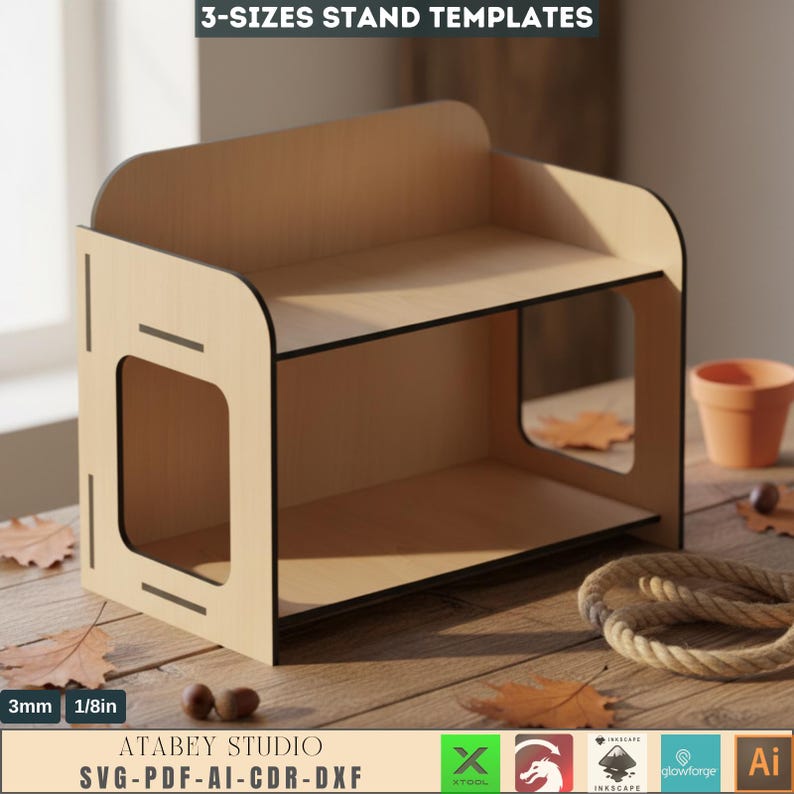 May include: A wooden stand with two shelves and a rectangular cutout on the side. The stand is made of light-colored wood with black trim. The text "3-SIZES STAND TEMPLATES" and "ATABEY STUDIO SVG-PDF-AI-CDR-DXF" are visible. The stand is 1/8in thick.