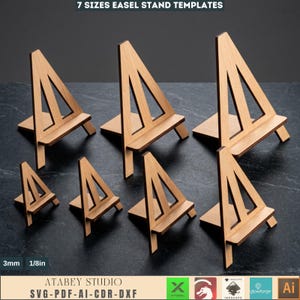 May include: A collection of seven wooden easel stand templates in various sizes. The stands are made of light-colored wood and feature a triangular design with a horizontal base. The text "7 SIZES EASEL STAND TEMPLATES" is at the top.