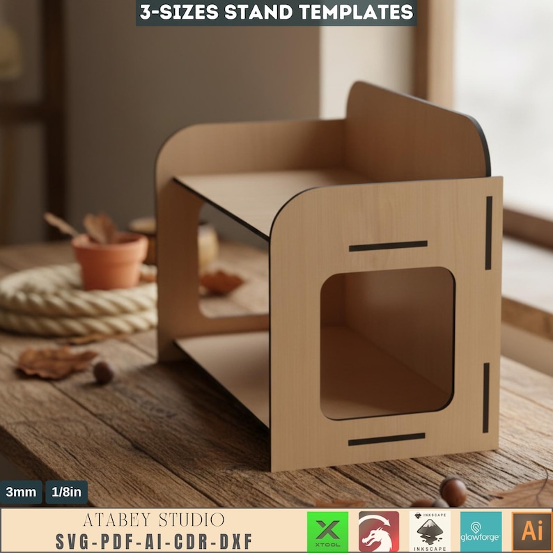 May include: A wooden stand with two shelves and a rectangular opening. The stand is made of light-colored wood with black accents. The text "3-SIZES STAND TEMPLATES" is at the top. The text "3mm 1/8in" is at the bottom, along with the text "ATABEY STUDIO SVG-PDF-AI-CDR-DXF".
