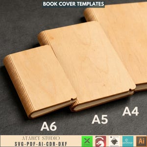 May include: Three wooden book cover templates in A6, A5, and A4 sizes. The covers are made of light-coloured wood and have a simple, clean design. The text "BOOK COVER TEMPLATES" is at the top. The bottom text says "ATABEY STUDIO SVG-PDF-AI-CDR-DXF".