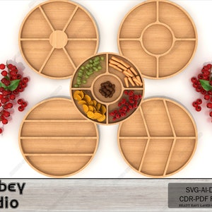 May include: Four round wooden serving trays with dividers, one tray is filled with snacks like nuts, crackers, and dried fruit. The trays are arranged in a circle on a white background.