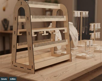 May include: A wooden jewelry display stand with multiple levels for showcasing earrings, necklaces, and other accessories. The stand has a light brown color and features various slots and hooks. The text "JEWELRY DISPLAY TEMPLATES" is at the top.