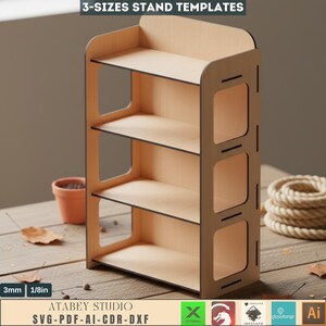 May include: A light-colored wooden stand with three shelves and a back panel. The stand has a rectangular shape with rounded corners and cut-out details. The text "3-SIZES STAND TEMPLATES" and "ATABEY STUDIO SVG-PDF-AI-CDR-DXF" are visible.