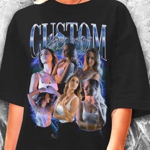May include: Black oversized t-shirt with a graphic print of five women with the text "CUSTOM Your name" in a blue and silver font.