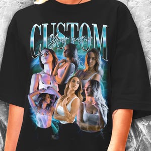 May include: Black oversized t-shirt with a graphic print of five women with the text "CUSTOM Your name" in a blue and silver font.