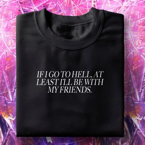 May include: Black crew neck sweatshirt with the text "IF I GO TO HELL, AT LEAST I'LL BE WITH MY FRIENDS" in white. The sweatshirt is displayed on a pink and purple abstract background.