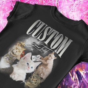 May include: Black t-shirt with a silver graphic that says "CUSTOM Your Text" and features a collage of four cats. The cats are in various poses and have different colored fur. One cat is wearing a crown.