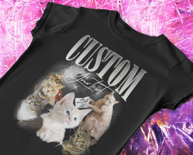 May include: Black t-shirt with a silver graphic that says "CUSTOM Your Text" and features a collage of four cats. The cats are in various poses and have different colored fur. One cat is wearing a crown.