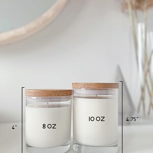 May include: Two glass candle jars with wooden lids. The smaller jar is 8 oz and the larger jar is 10 oz. The jars are on a white surface.