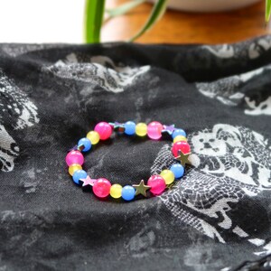 Pansexual/Panromantic pride flag star beaded gemstone bracelet. The beads are the pan flag colors (pink, yellow, cyan) and holographic stars.