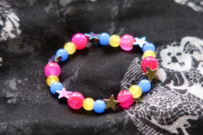 Pansexual/Panromantic pride flag star beaded gemstone bracelet. The beads are the pan flag colors (pink, yellow, cyan) and holographic stars.
