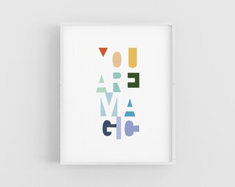 May include: A white framed print with the text "YOU ARE MAGIC" in colorful, geometric letters.