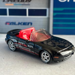 Hot Wheels black Mazda Miata 91 with custom wheel swap mainline