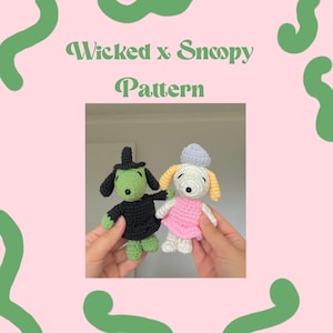 May include: Two crochet Snoopy dolls, one dressed as a witch in black and green, the other in a pink dress and blue hat. The text "Wicked x Snoopy Pattern" is displayed on a pink background with green accents.