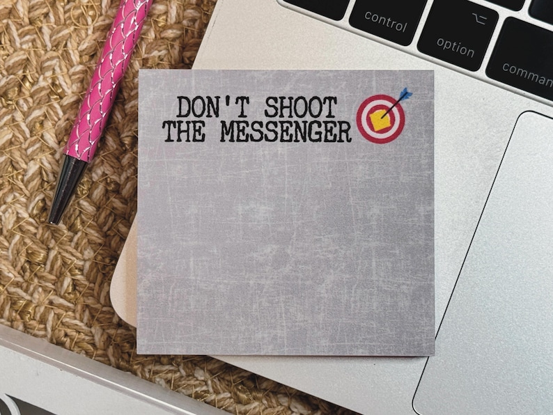 May include: A gray sticky note with the text "DON'T SHOOT THE MESSENGER" in black font. A red target with a yellow bullseye and a blue arrow is in the upper right corner.
