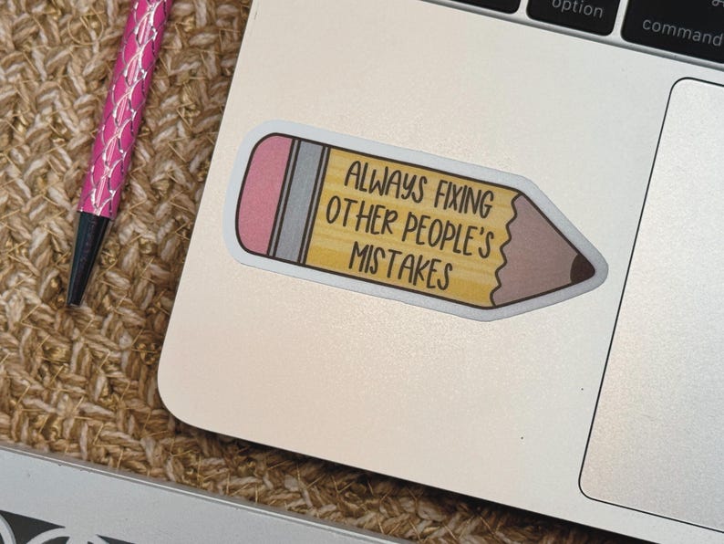 Puede incluir: Una pegatina con forma de l&aacute;piz con cuerpo amarillo, goma de borrar rosa y punta marr&oacute;n oscuro. La pegatina presenta el texto negro "ALWAYS FIXING OTHER PEOPLE'S MISTAKES" impreso claramente en el centro del cuerpo amarillo del l&aacute;piz.