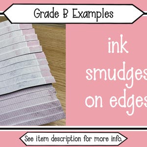 May include: A stack of rectangular paper strips with visible ink smudges on the edges. The image includes the text Grade B Examples and ink smudges on edges, along with a bottom banner stating See item description for more info.