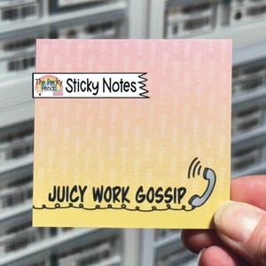 May include: A square sticky note with a gradient from pink at the top to yellow at the bottom, featuring a subtle exclamation mark pattern. The text reads "The Perky Pencil Sticky Notes" and "JUICY WORK GOSSIP" next to a telephone handset icon.