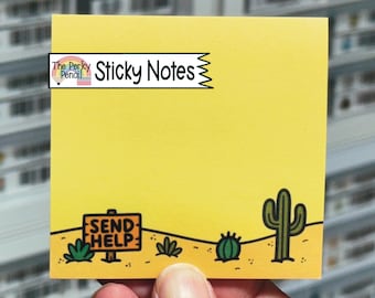 May include: A square yellow sticky note featuring a desert landscape illustration at the bottom with a sign that reads SEND HELP, a small green cactus, and a larger saguaro cactus. A logo in the top left corner displays The Perky Pencil Sticky Notes.