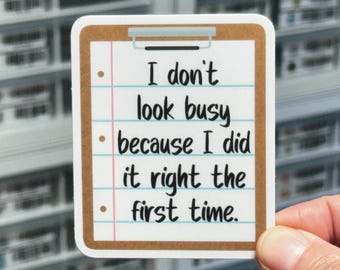May include: A rectangular sticker shaped like a clipboard with a brown border and white lined paper background. The text in black font reads: I don't look busy because I did it right the first time. The sticker features three brown bullet points.